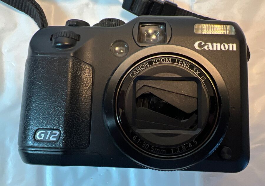 Canon PowerShot G12 black compact digital camera bundle with camera strap, removable battery, charger, cable, memory card, and black Canon carrying case